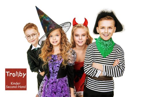 Group of cute children wearing Halloween costumes happily pose on a white yellow background. Happy Halloween!